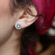 Model wearing 14kt diamond filigree earrings with pink headscarf