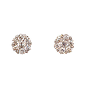 Close-up of 14kt white gold 6mm diamond cluster earrings on white background