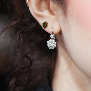 Model wearing 18kt silver-topped old-mine cut diamond flower earrings