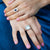 Model wearing a bold 18kt white gold cloudy aqua cabochon ring with diamond-set eagle prongs