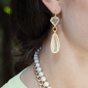 Woman wearing long 18kt yellow gold drop earrings with Mexican opals and citrine accent stones