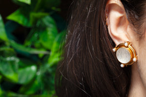 Elizabeth Locke intaglio earrings with pearls shown on model's ear