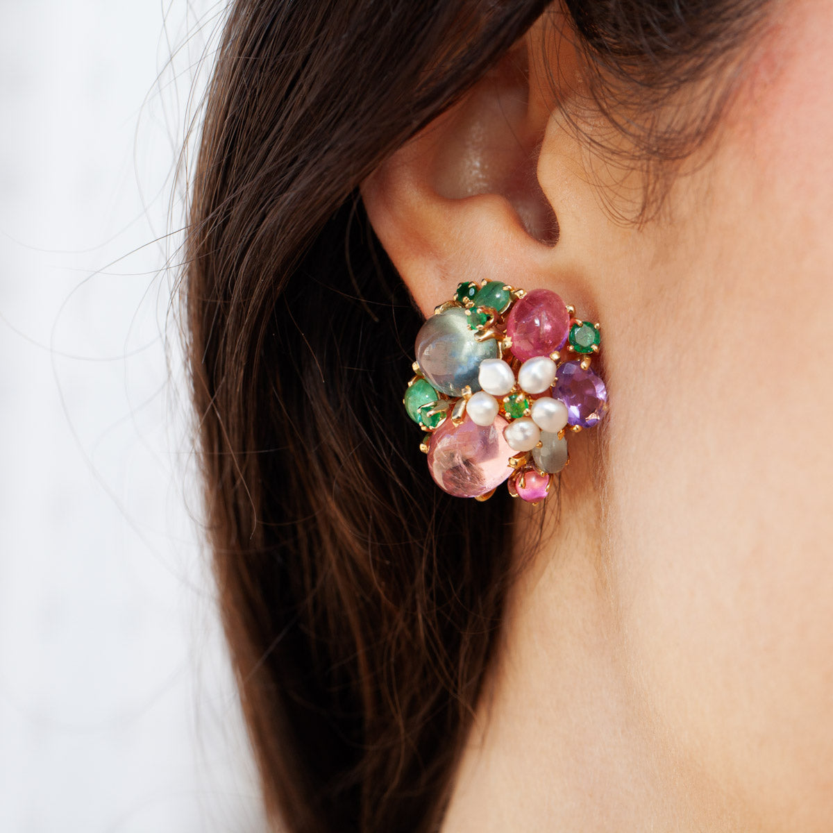 On model of vintage 14kt yellow gold bouquet earrings with tourmaline, emeralds, and pearls