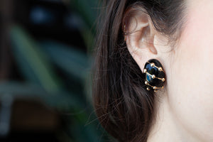 Model wearing Tiffany & Co. Schlumberger vintage enamel banana earrings