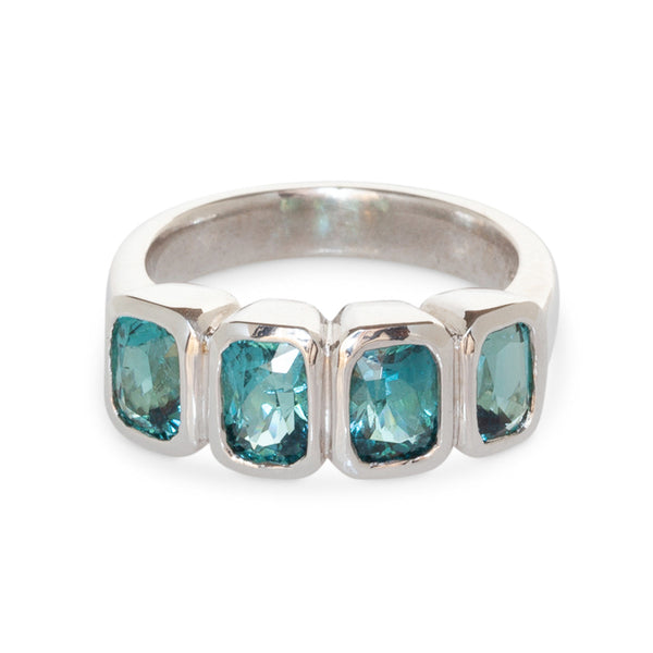 Front view of 14kt white gold bezel-set ring featuring four blue tourmalines totaling 3.01 carats