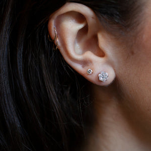 14kt white gold 6mm diamond cluster earrings shown on ear for scale