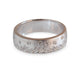 Studio image of a brushed 14kt white gold band with scattered round diamonds
