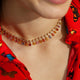 Colorful 14kt yellow gold and diamond necklace styled on model’s neck