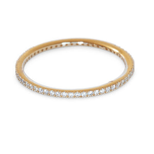 Close-up of 14KT yellow gold diamond eternity band ring