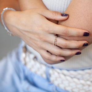 Model wearing 14KT yellow gold diamond eternity band stacked with other ring