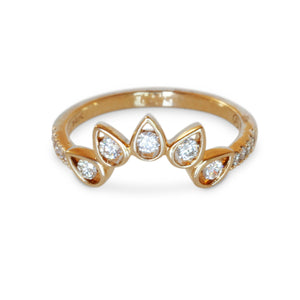 Close-up of 14KT yellow gold curved ring with pear-shaped bezel diamonds