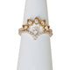 14KT yellow gold diamond curved ring stacked with other bands on ring display