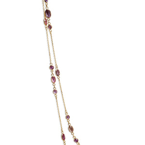 Close-up of pink sapphire stones on yellow gold chain